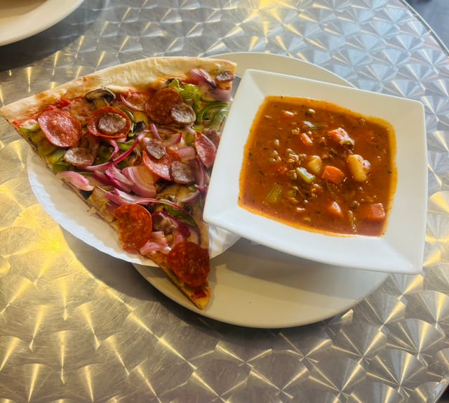 5. Manhattan clam chowder with a slice.