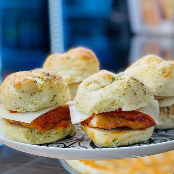 Al's Famous Pizza's mini chicken parmesan sliders with cheese and marinara on herbed buns.